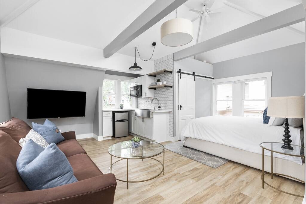 Modern Carriage House, an open living space with a kitchenette and beamed ceiling in Indianapolis, Indiana