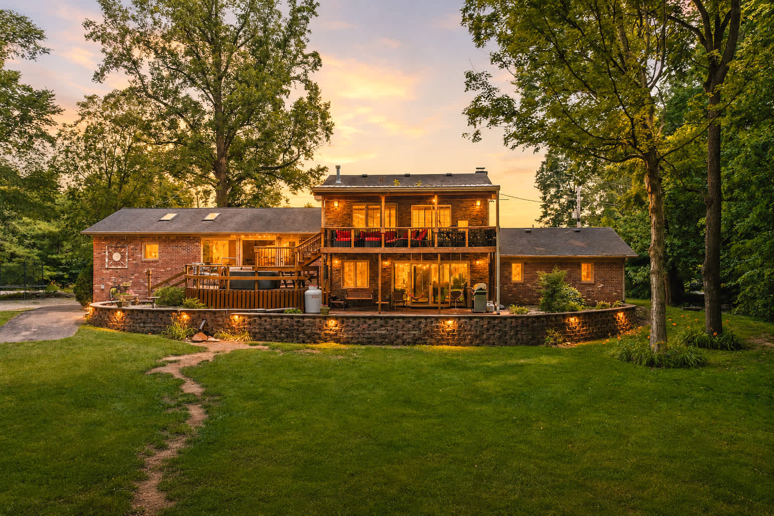 Riverside Haven, a brick home with a two-level deck, hammock and grill in Fishers, Indiana