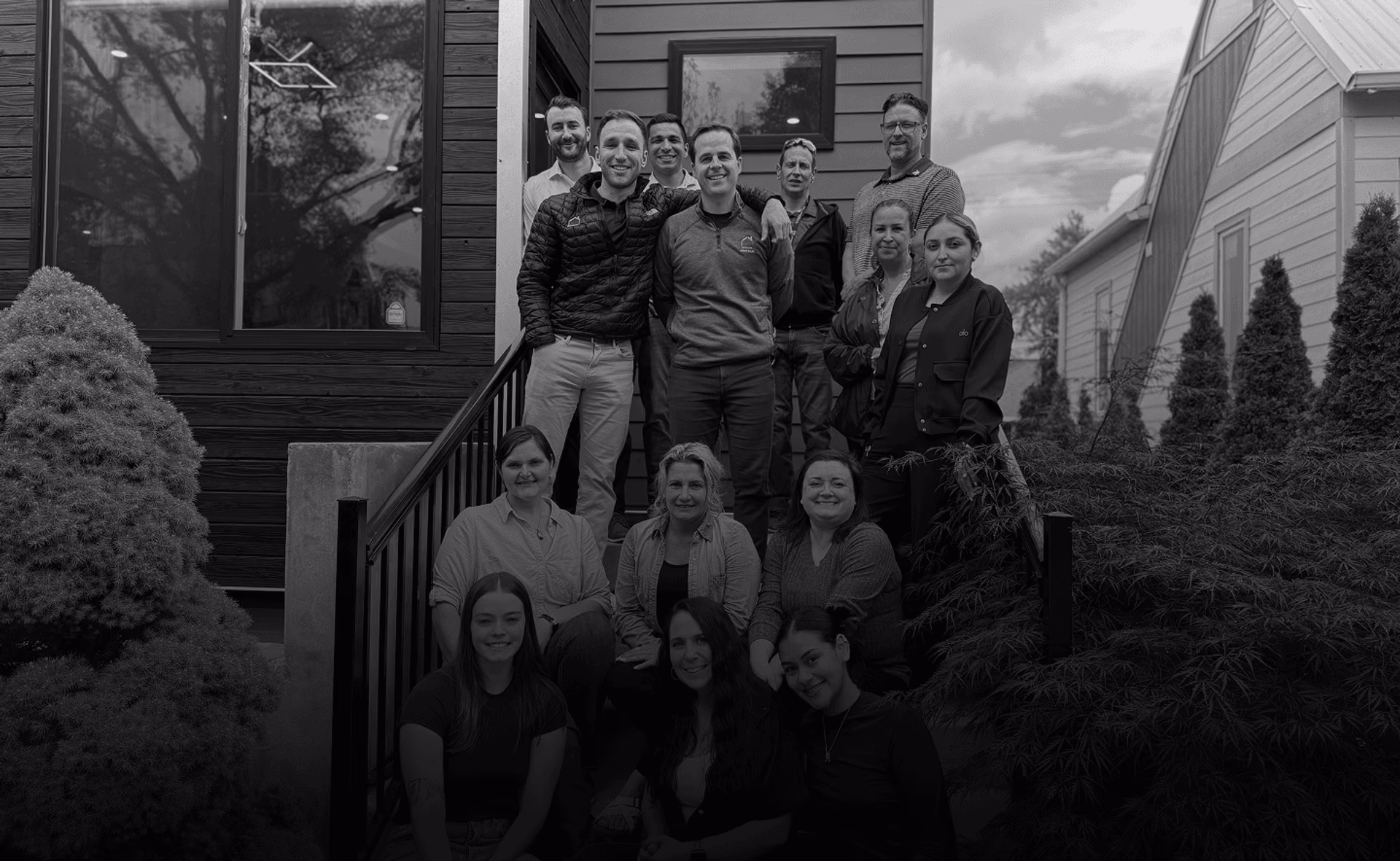 The Home Base team together on the steps of one of their homes