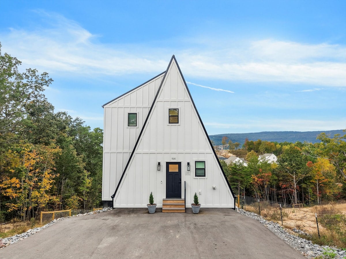 A white Home Base A-frame cabin on a bluff outside Chattanooga