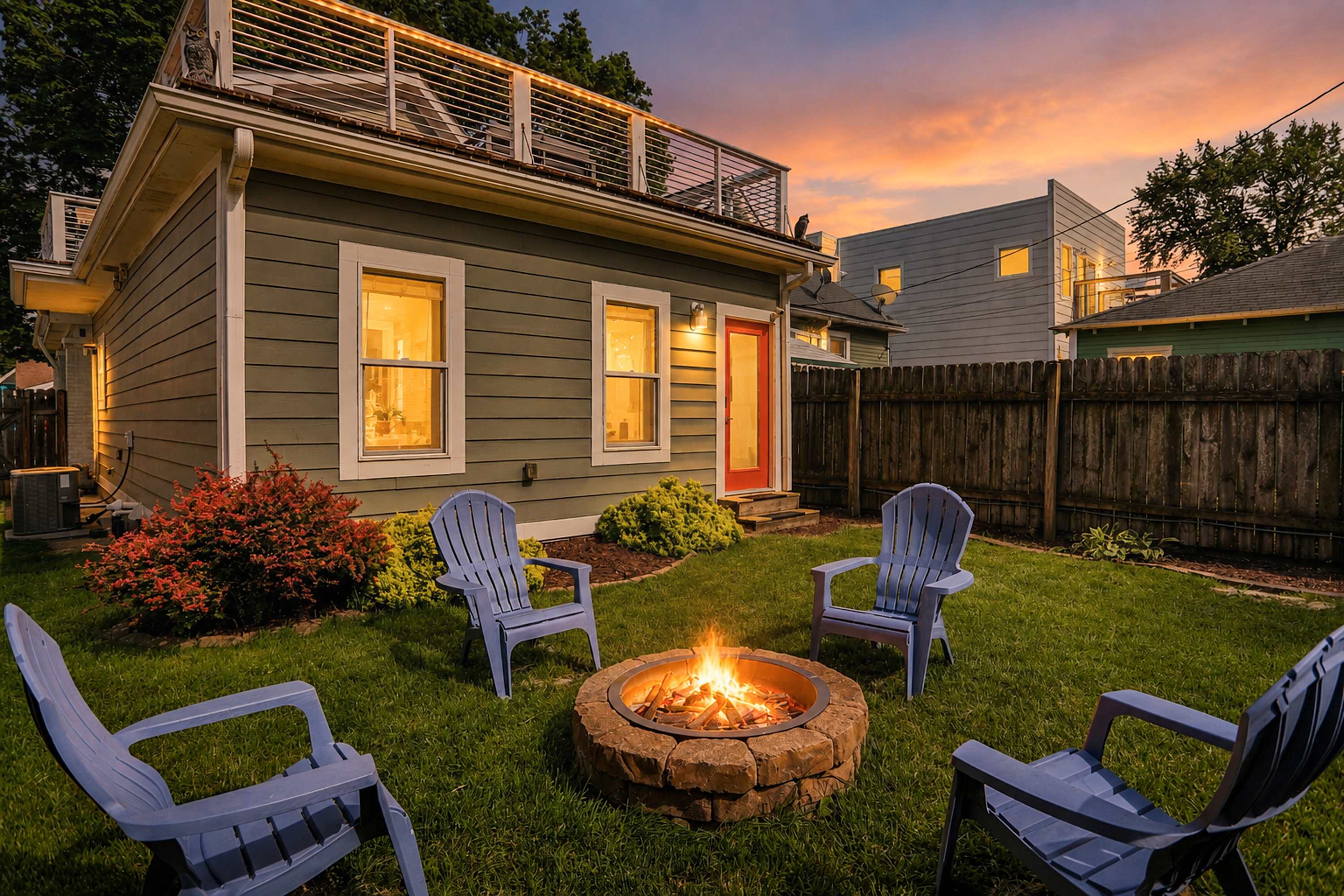 Linden House at dusk, a Home Base managed home with a lit fire pit in Indianapolis